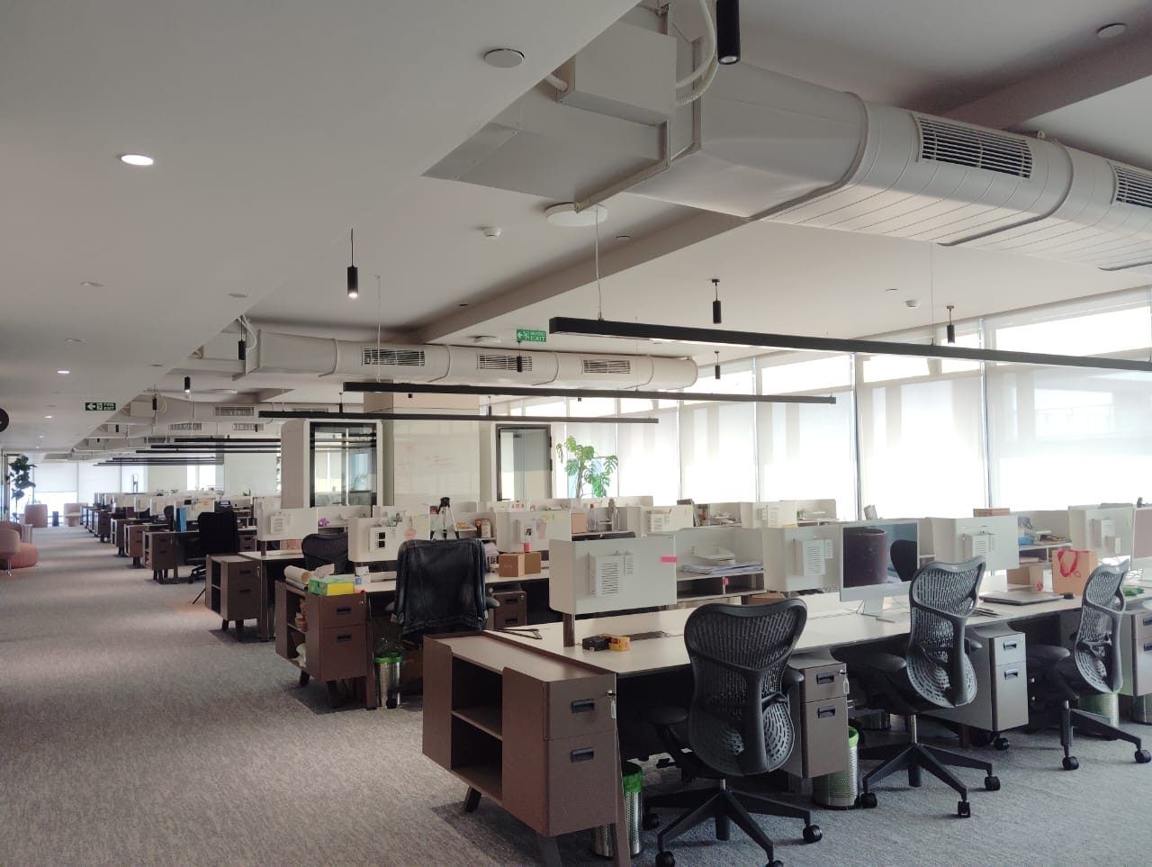Open-plan office floor with exposed services