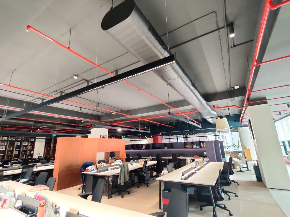 Open-plan floor with exposed ductwork and sprinkler pipework